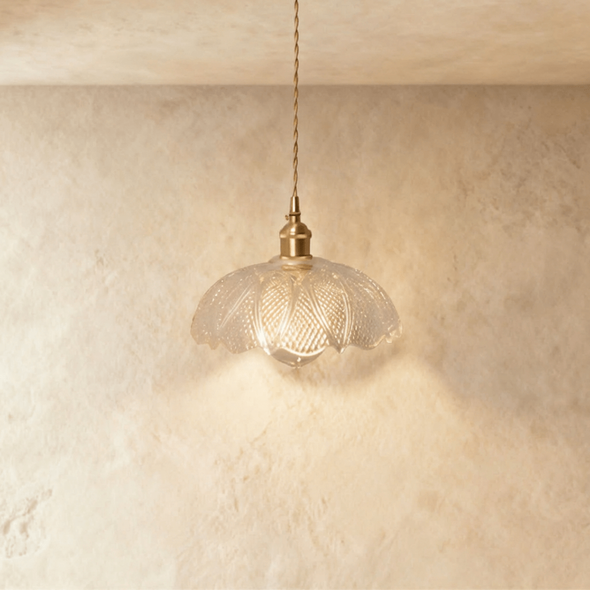 Clérachic Isabel pendant light, a finely pleated clear glass flower shade with an exposed teardrop bulb below.