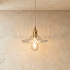 Clérachic Isabel pendant light, a pleated clear glass saucer shade with a pinked scalloped edge and exposed bulb.