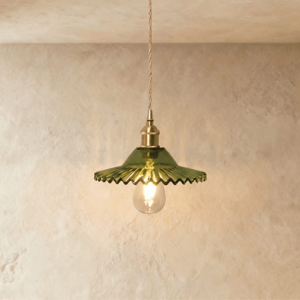 Clérachic Isabel pendant light, a ruffled green-tinted glass petal shade catching light on a brass fitting.
