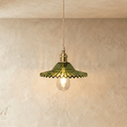 Clérachic Isabel pendant light, a ruffled green-tinted glass petal shade catching light on a brass fitting.