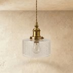 Clérachic Isabel pendant light, a compact clear glass drum shade with a fine chevron texture glowing warm white.