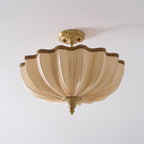 Clérachic semi-flush light, unlit, on a pale ceiling, the pleated cream fabric folded in soft vertical ribs.
