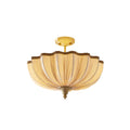 Clérachic semi-flush ceiling light on a white background, with its pleated cream shade, braided edge and bright brass ceiling plate.