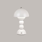 White Clérachic dome lamp on a grey backdrop, with a small charging port visible at the base.