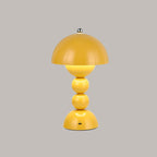 Yellow Clérachic dome lamp with a lit inner glow and a small charging port at the base, on a grey backdrop.