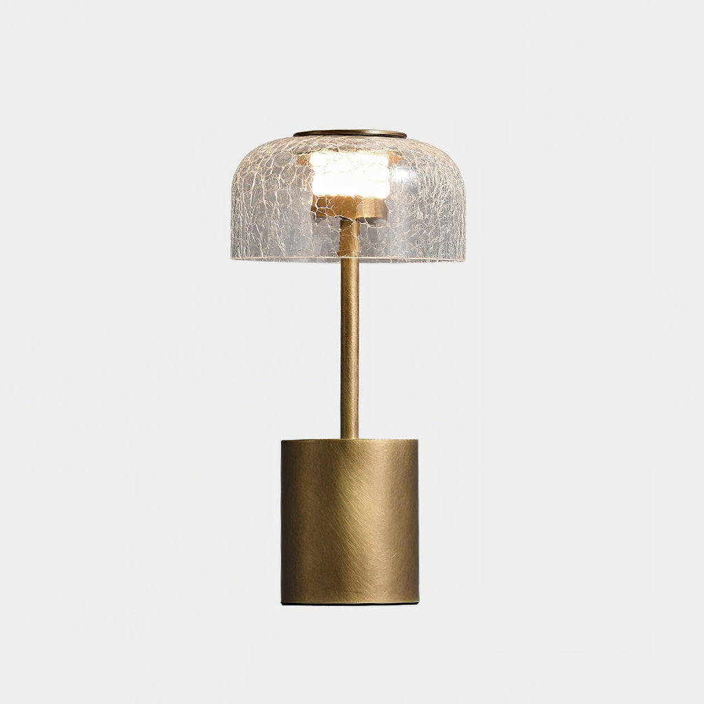 The Clérachic table lamp unlit and cut out, with its crackle glass dome, bronze stem and round base on a white background.