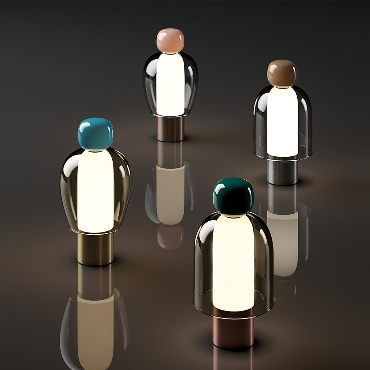 Four Clérachic table lamps with different cap colours, lit from within and reflected in a dark glossy surface.