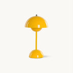 A yellow dome-shaped Clérachic table lamp with a slim stem and a rounded base, on a plain white backdrop.