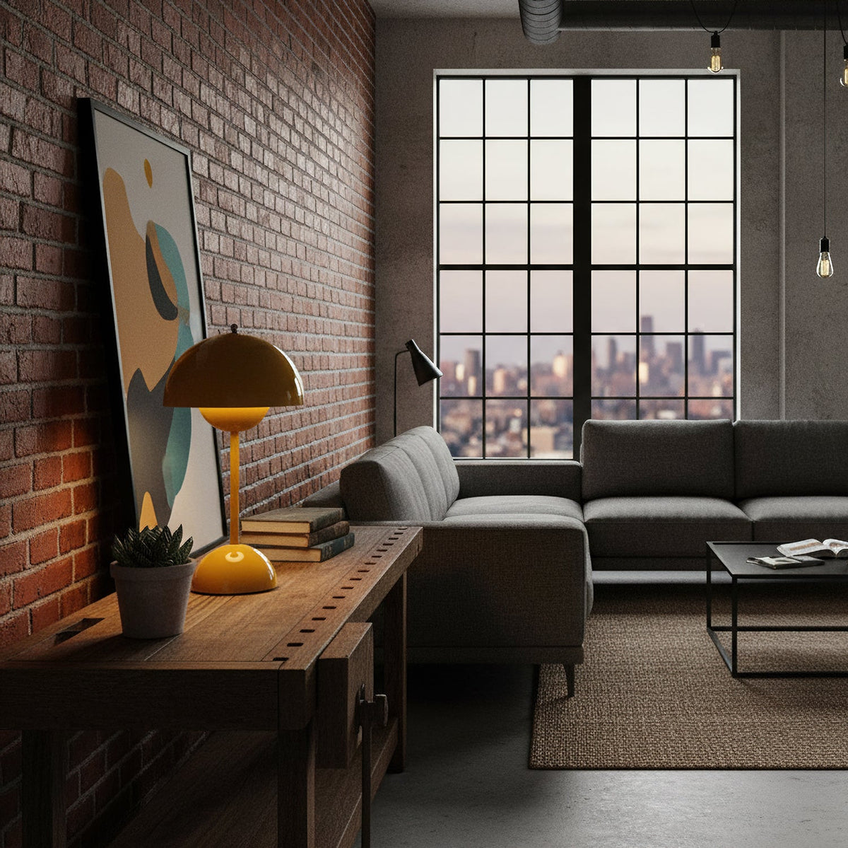 This Clérachic table lamp in mustard stands on a dark wooden console in a loft with a brick wall and a tall window.