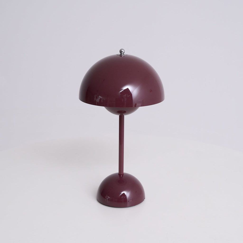 Front view of this Clérachic table lamp in deep plum, on a soft grey backdrop, with a glossy dome shade and slim stem.