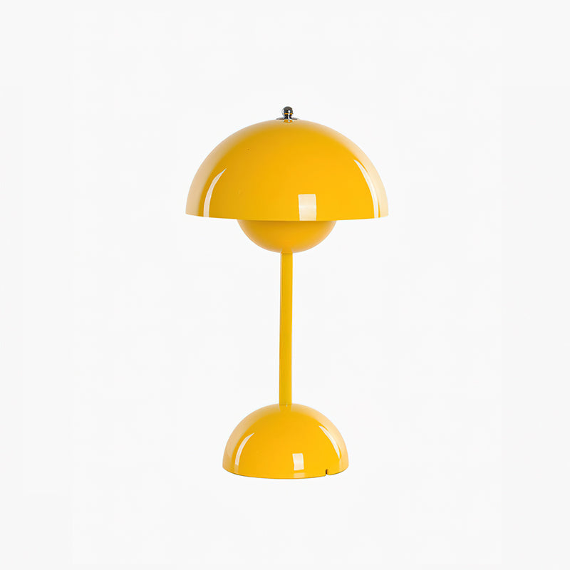 A yellow Clérachic table lamp, with a glossy dome shade and a rounded base, on a plain white backdrop.
