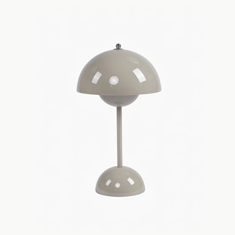 A greige Clérachic table lamp with a glossy dome shade and a rounded base, on a plain white backdrop.