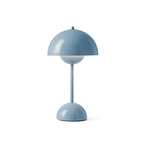 A light-blue Clérachic table lamp with a dome shade and a rounded base, on a plain white backdrop.