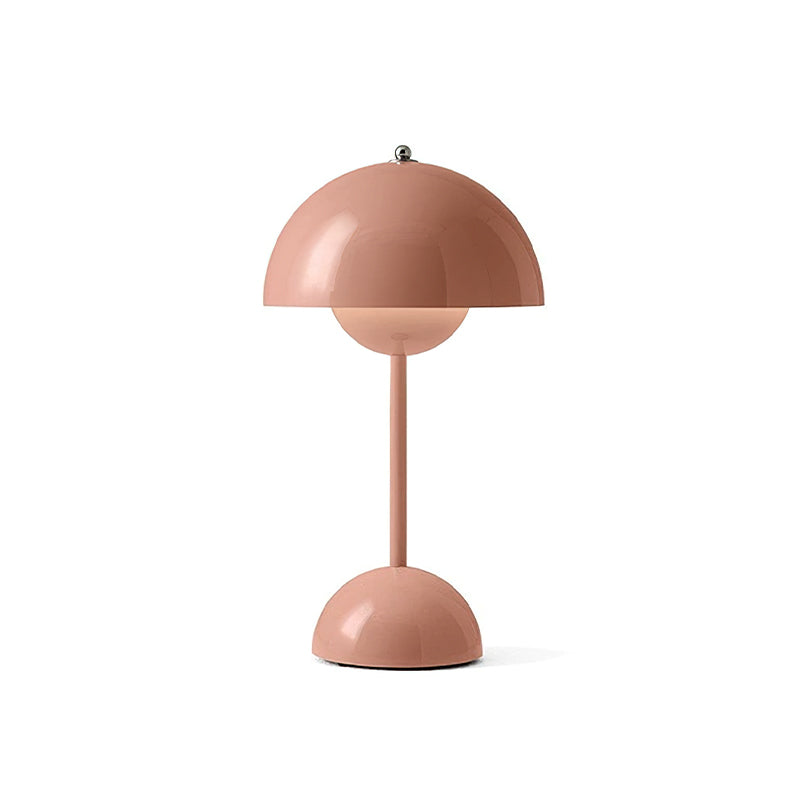 A blush-pink Clérachic table lamp with a glossy dome shade and a slim stem, on a plain white backdrop.