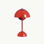 A red Clérachic table lamp with a glossy dome shade and a rounded base, on a plain white backdrop.