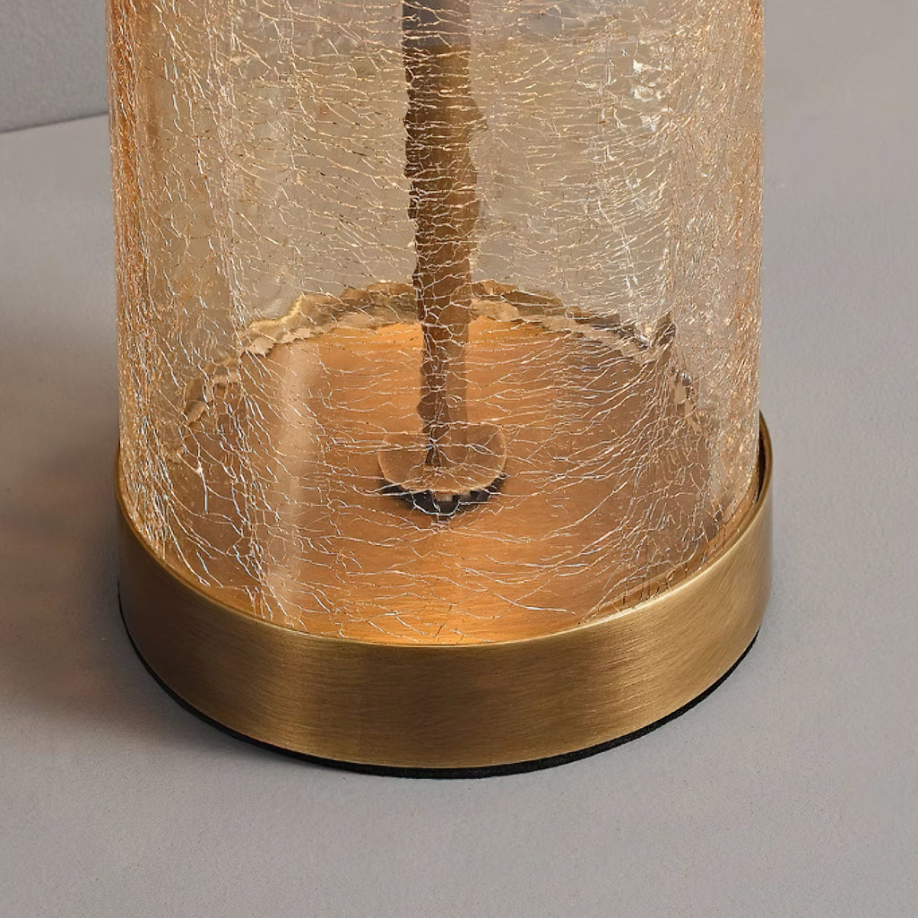 Close view of the bronze base ring and crackled glass cylinder at the foot of this Clérachic table lamp.