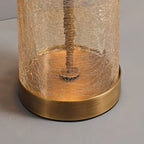 Close view of the bronze base ring and crackled glass cylinder at the foot of this Clérachic table lamp.