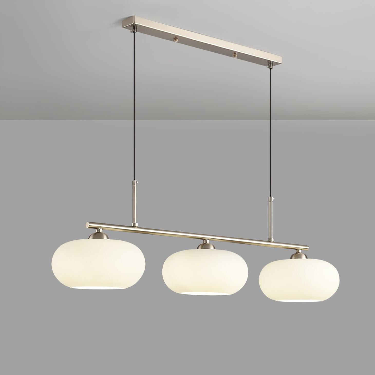 Clérachic cream glass 3-light cluster on a silver bar, three lit oval shades against a plain grey studio ground.