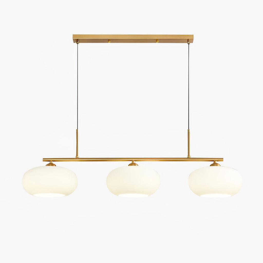 Clérachic cream glass 3-light cluster, gold canopy and bar, three lit pebble shades on a clean white backdrop.