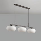 Low-angle studio view of the Clérachic cream glass 3-light cluster on a silver bar, open shade bottoms visible.