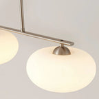 Clérachic silver-frame cream glass pendant, close-up of the bar, vertical rod, and two lit oval shades.