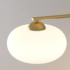 High-angle close-up of one Clérachic cream glass shade on the gold cluster, gold cap and bar extending right.