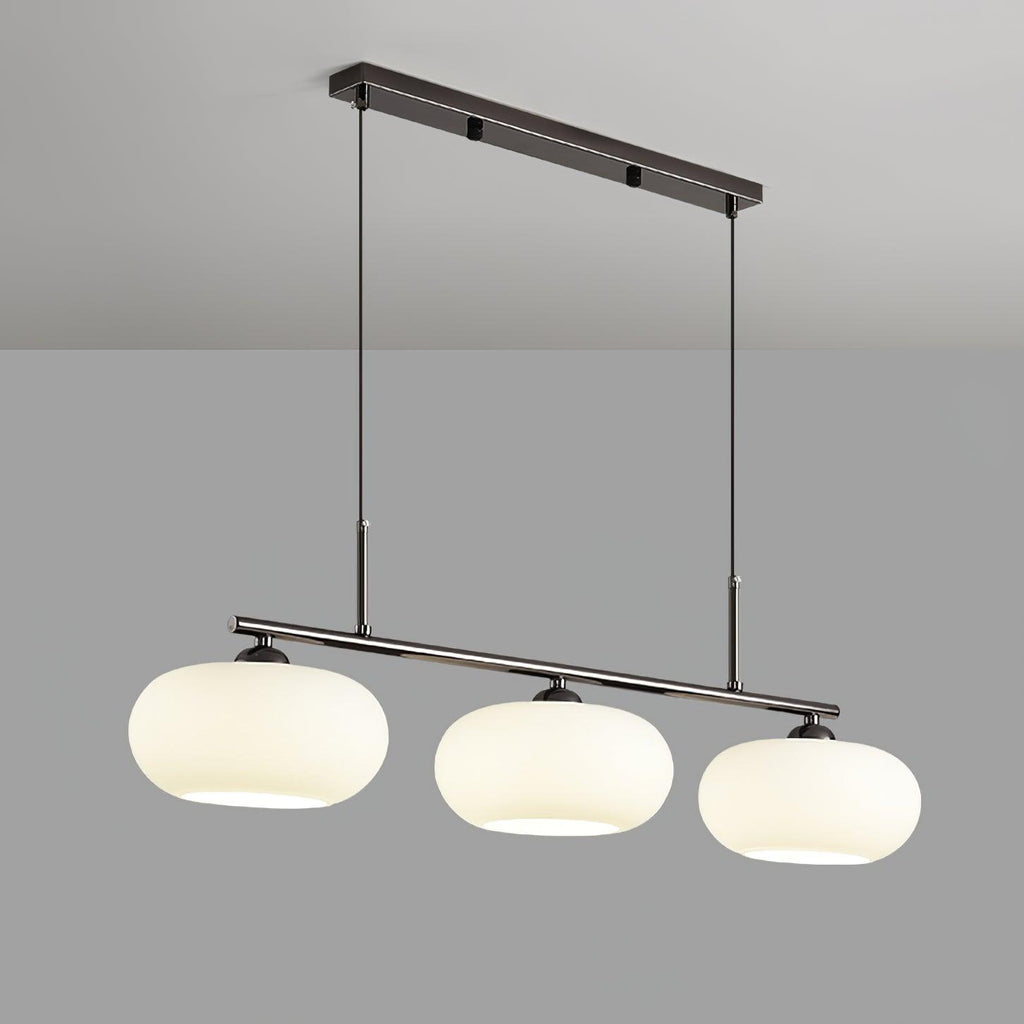 Clérachic cream glass 3-light cluster on a silver canopy and bar, three lit shades against a pale grey wall.