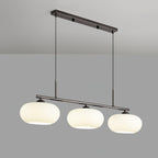 Clérachic cream glass 3-light cluster on a silver canopy and bar, three lit shades against a pale grey wall.