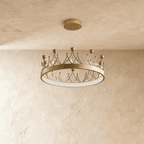 Clérachic gold crown chandelier with a flat ring, small crystal drops and ball tips, hung on fine wires from a round canopy.