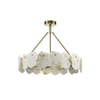 Clérachic Cryon chandelier unlit on white, its brushed brass frame ringed with overlapping raw-cut alabaster plates.