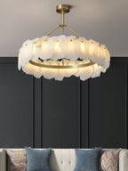 The Clérachic Cryon glowing against a charcoal panelled wall above a cushioned bench and patterned pillows.