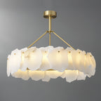 Clérachic Cryon from the side on grey, showing how the alabaster plates wrap the lit brass band all round.
