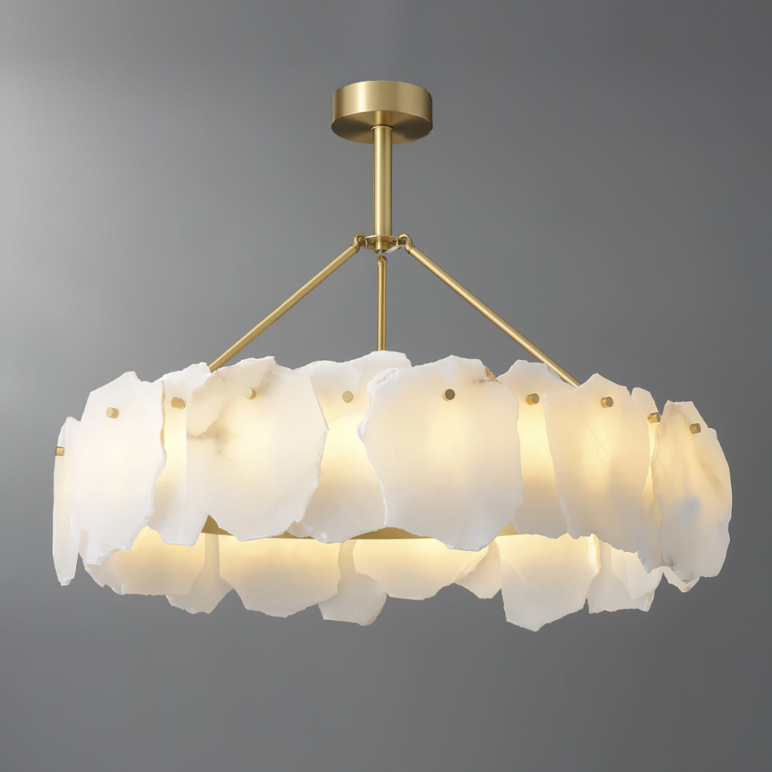 Clérachic Cryon from the side on grey, showing how the alabaster plates wrap the lit brass band all round.