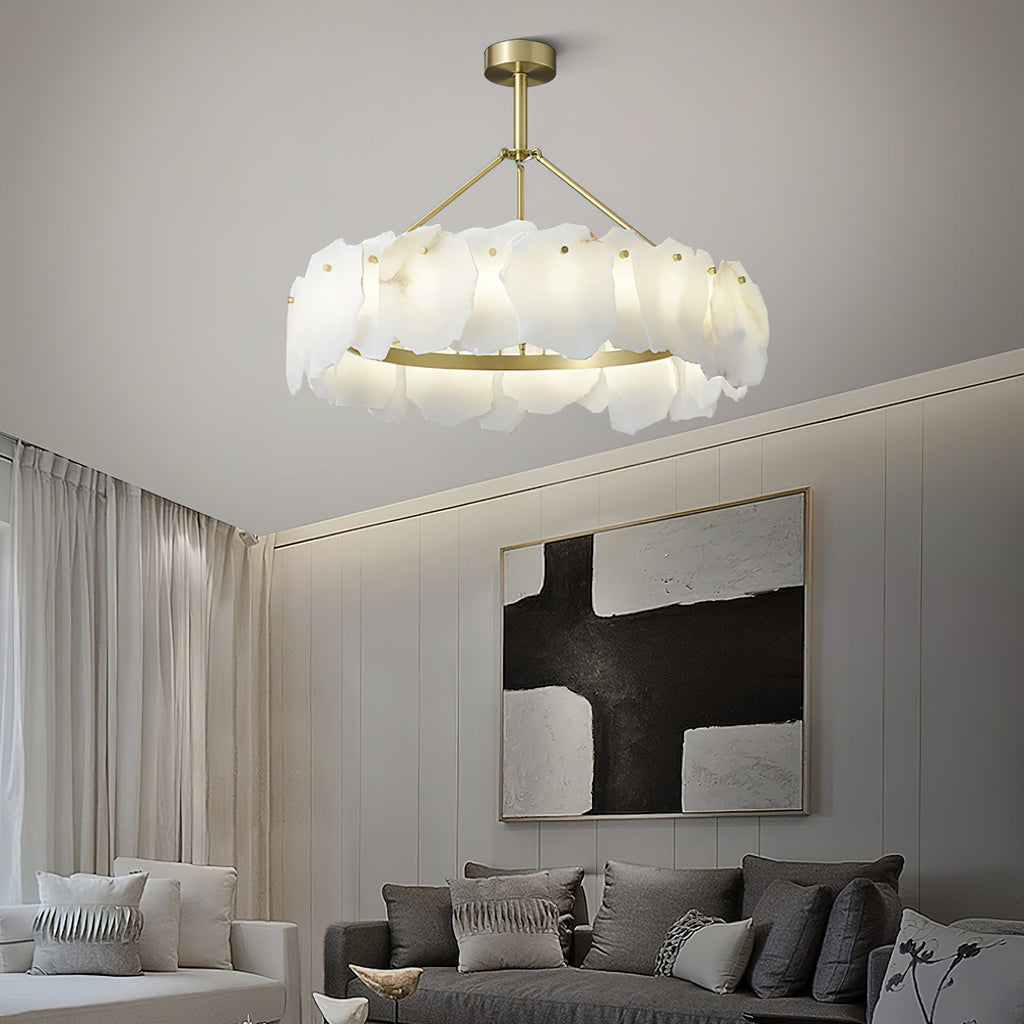 The Clérachic Cryon lit in a pale sitting room, floating above a grey sofa and a black-and-white canvas.