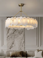 The Clérachic Cryon lit beside a stone-clad column, its layered alabaster shades echoing the veined marble.