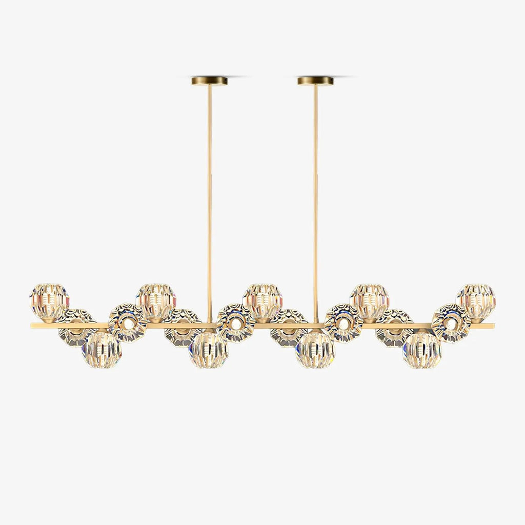 Linear brass bar with clear faceted crystal balls on two slim rods, shown on a white backdrop as this Clérachic chandelier.