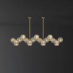 Brass bar with clear crystal balls on a plain charcoal wall, a Clérachic chandelier with two ceiling rods.