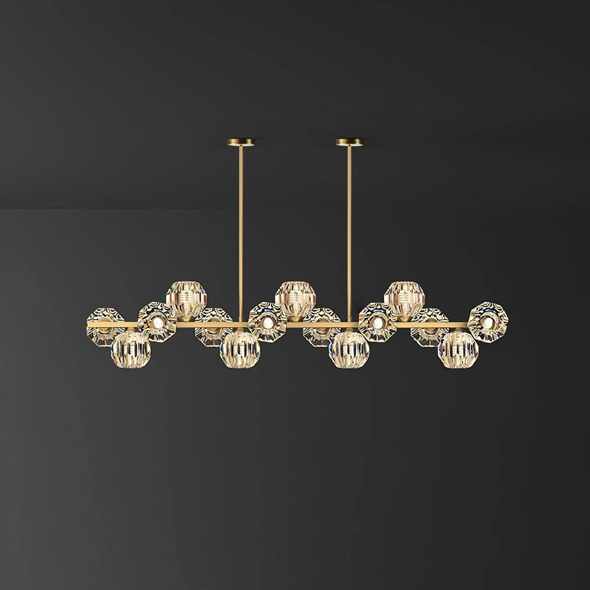Brass bar with clear crystal balls on a plain charcoal wall, a Clérachic chandelier with two ceiling rods.