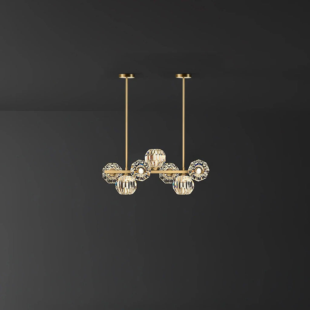 Smaller seven-head version of this Clérachic chandelier on a dark grey backdrop, two brass rods rising to round canopies.