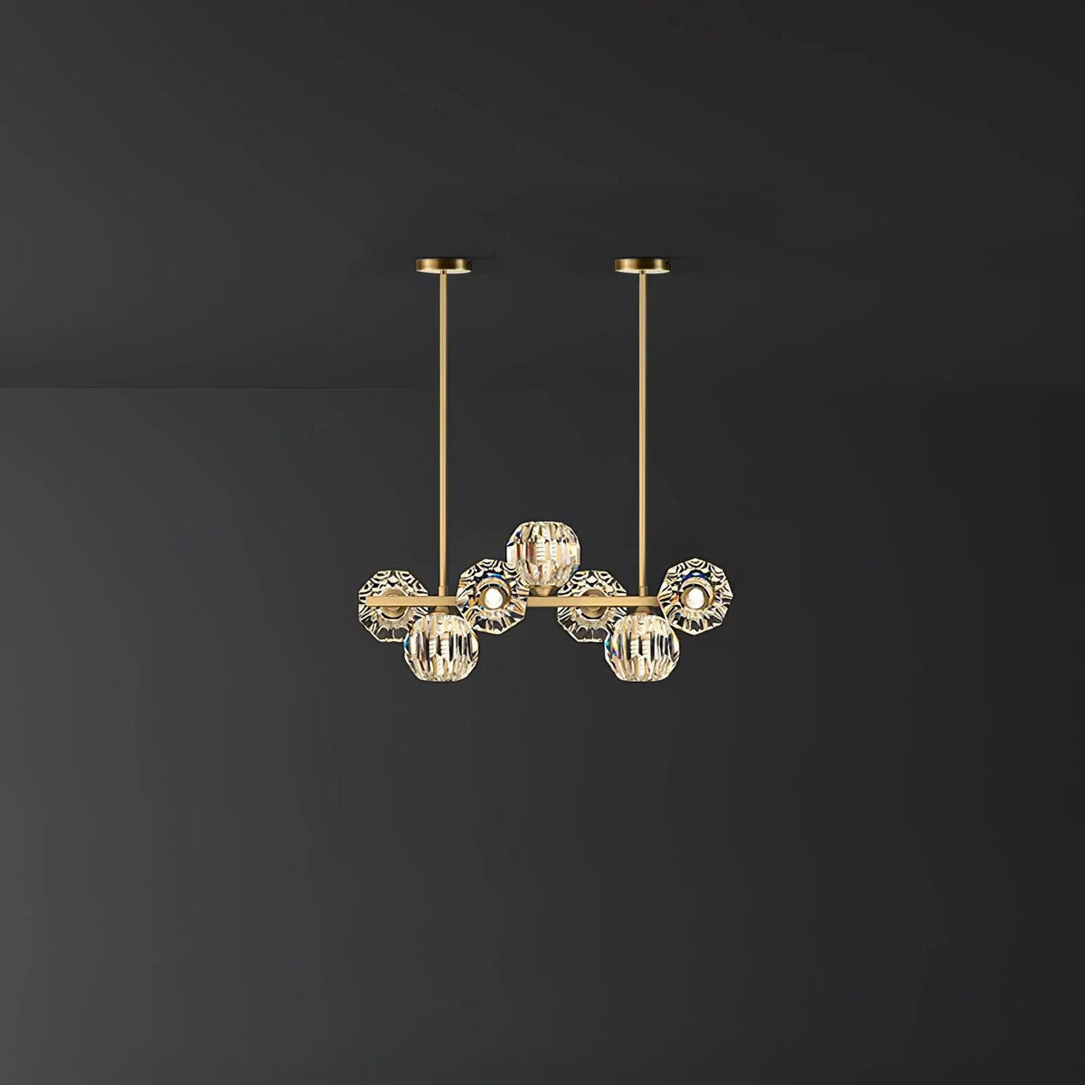 Smaller seven-head version of this Clérachic chandelier on a dark grey backdrop, two brass rods rising to round canopies.