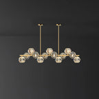 Mid-length brass bar with crystal balls and two round ceiling canopies on a dark grey wall, a Clérachic chandelier.