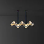 Eleven-head style on a dark backdrop: a brass bar, clear faceted balls and two thin rods from this Clérachic chandelier.
