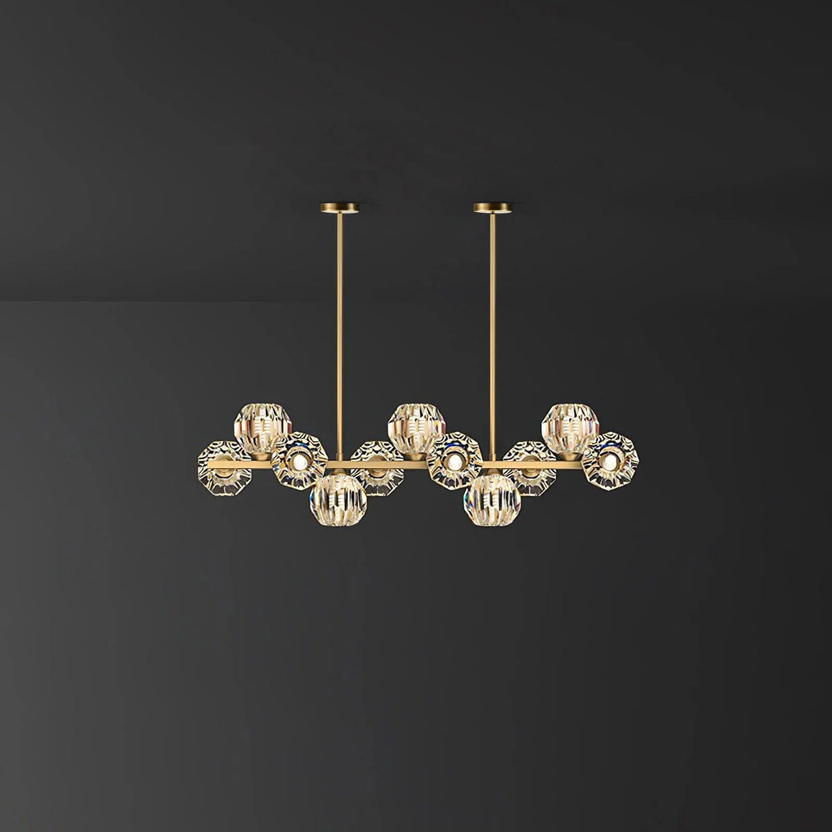 Eleven-head style on a dark backdrop: a brass bar, clear faceted balls and two thin rods from this Clérachic chandelier.