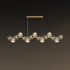 Long brass bar on a rectangular canopy, crystal balls spread evenly, shown on a muted brown wall as a Clérachic chandelier.