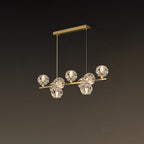 Angled view of the brass bar and its clear crystal balls on a rectangular canopy, a smaller Clérachic chandelier.