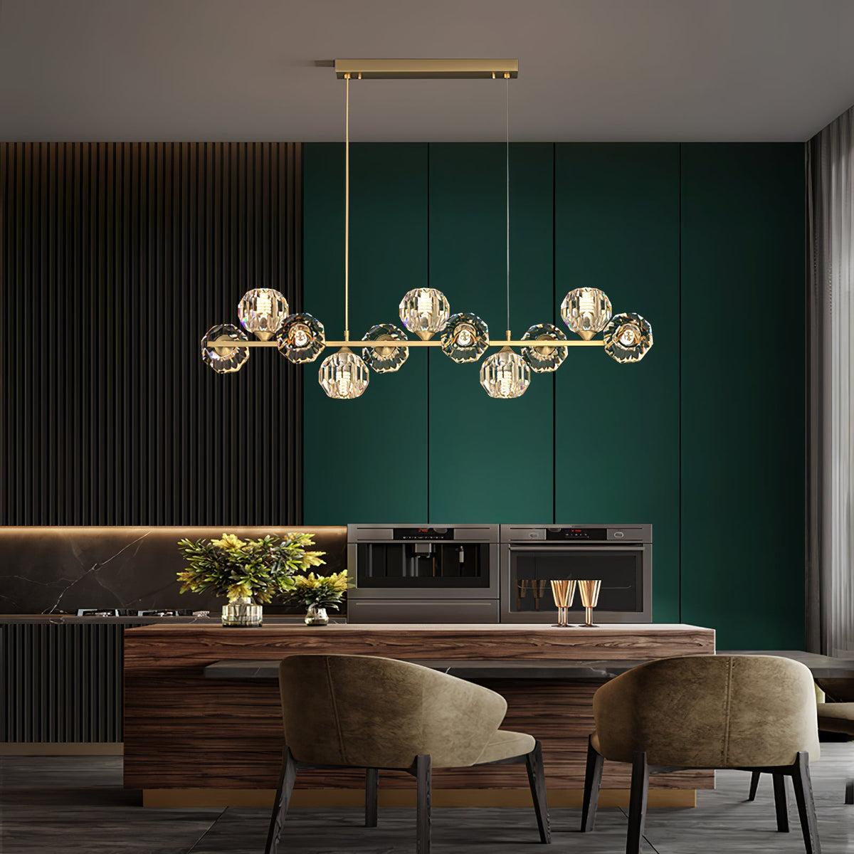 Over a wooden dining island with two olive armchairs, this Clérachic chandelier sits against green and dark panelling.