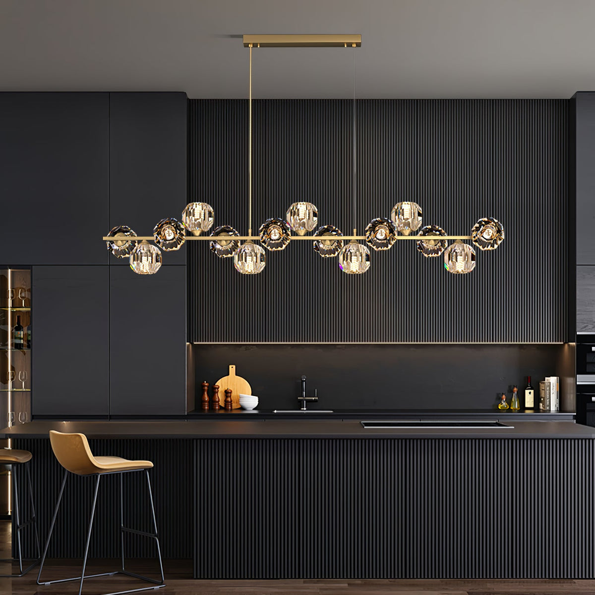 Hung from a rectangular canopy, this Clérachic chandelier spans a charcoal fluted kitchen with a tan bar stool beside it.