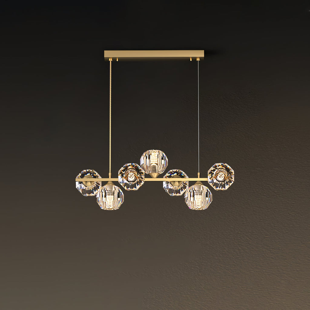 Seven crystal balls on a short brass bar, this Clérachic chandelier hanging from a rectangular canopy on a brown wall.