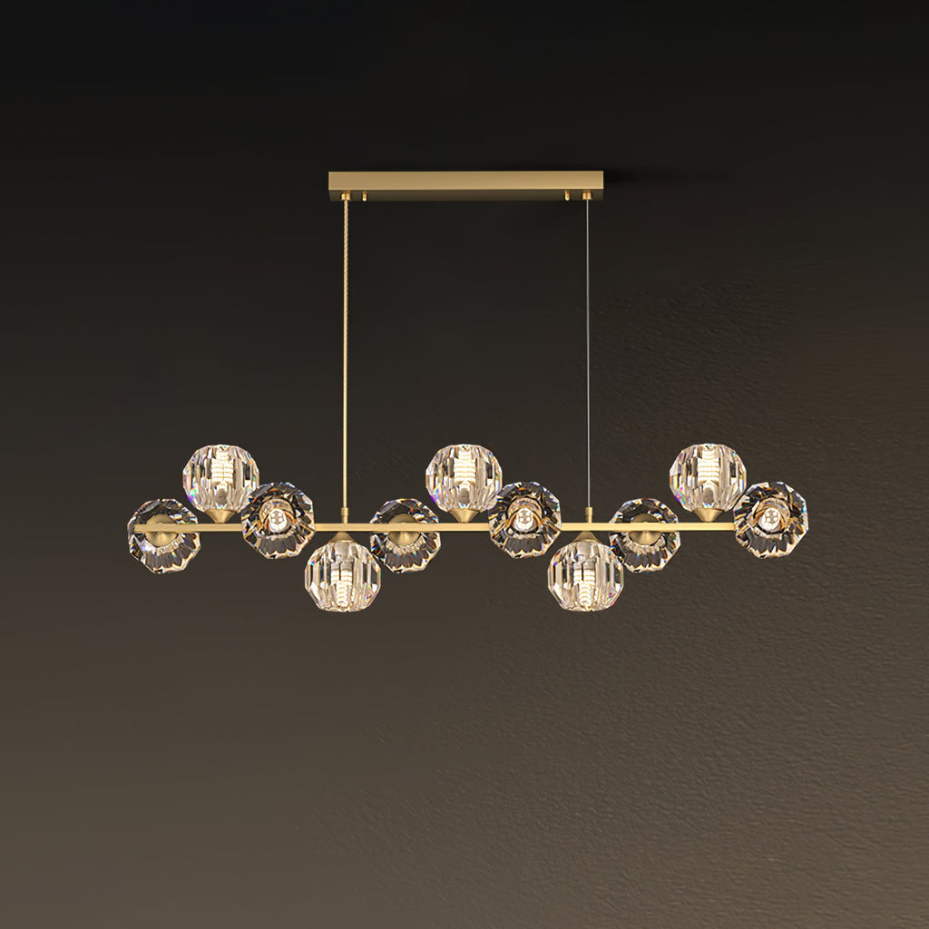 Nine crystal balls along a brass bar, a Clérachic chandelier with a rectangular canopy and two fine cords on a brown backdrop.