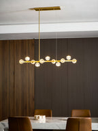 Tilted up from below, this Clérachic chandelier glows on a rectangular canopy above a marble table and leather chairs.